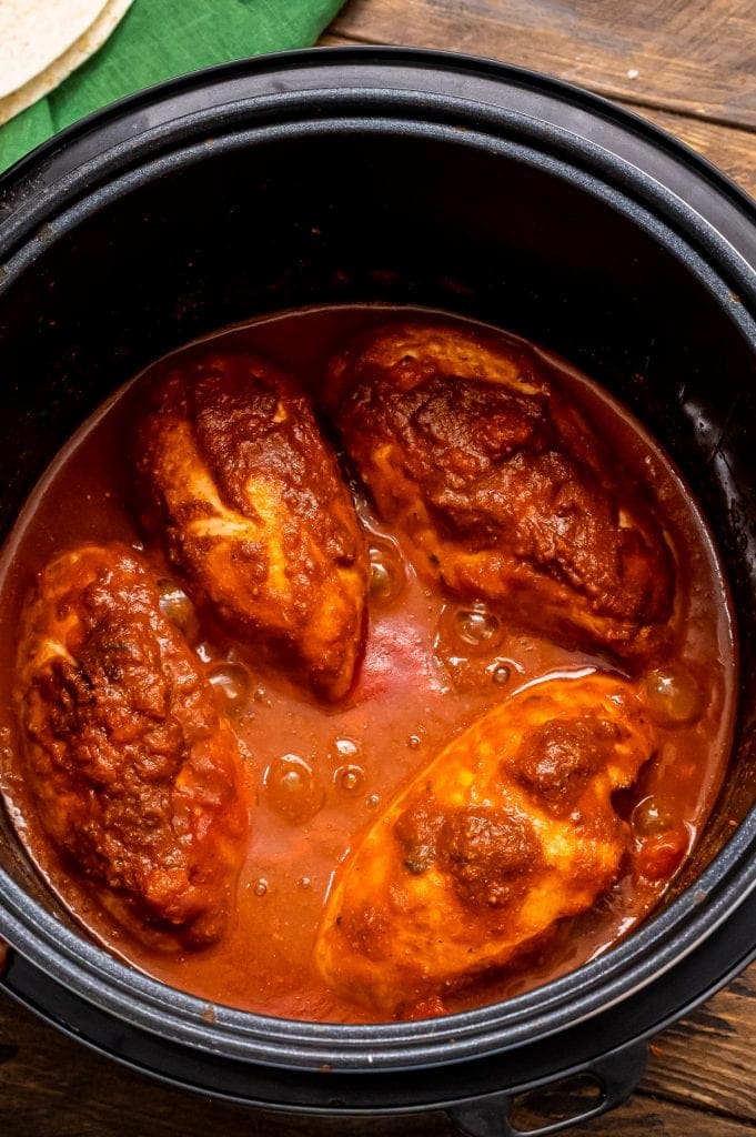 Instant Pot liner with cooked chicken, salsa, taco seasoning and water