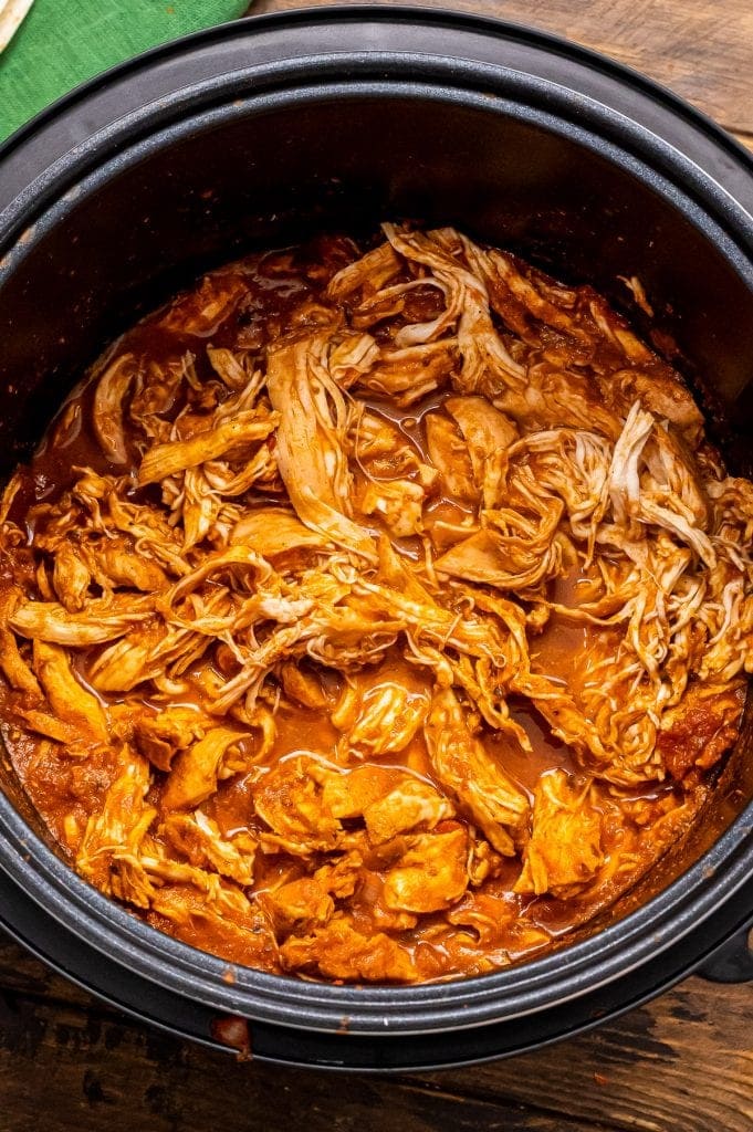 Instant Pot Liner with shredded chicken that has been seasoned with taco seasoning and salsa