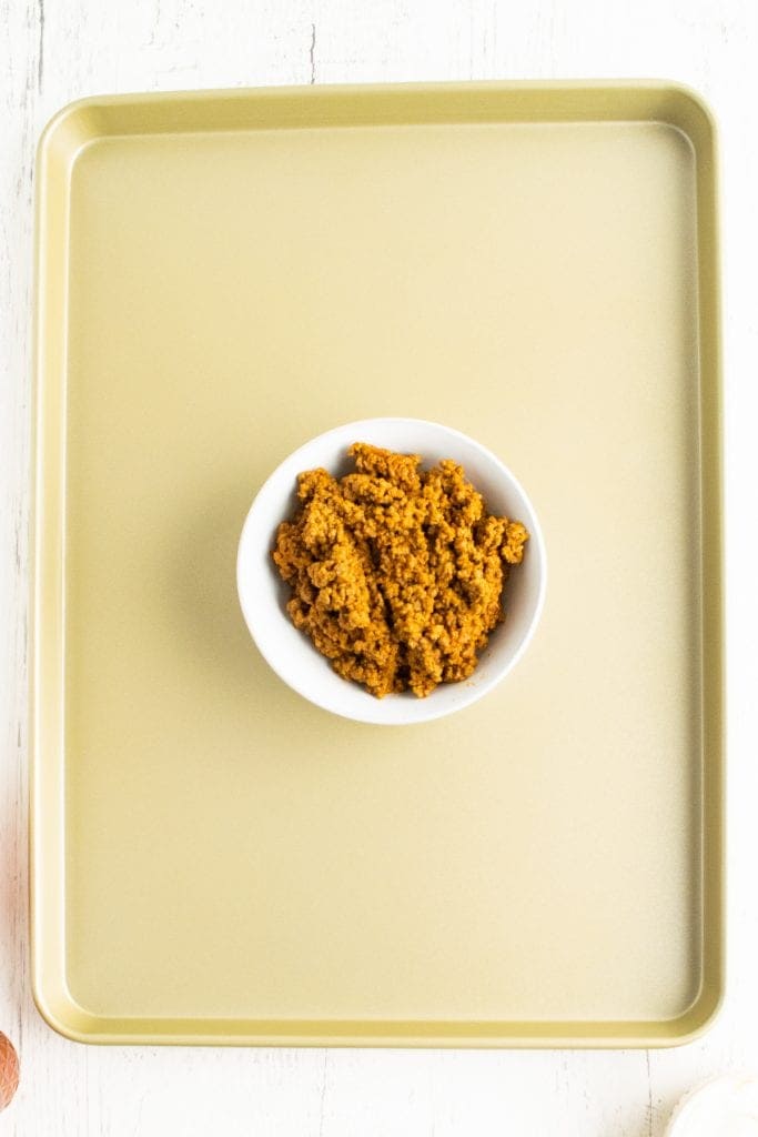 Overhead photo of sheet pan with a bowl of hamburger in the middle