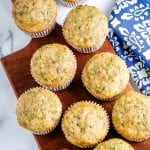 Overhead image of zucchini muffins on wood cutting board.