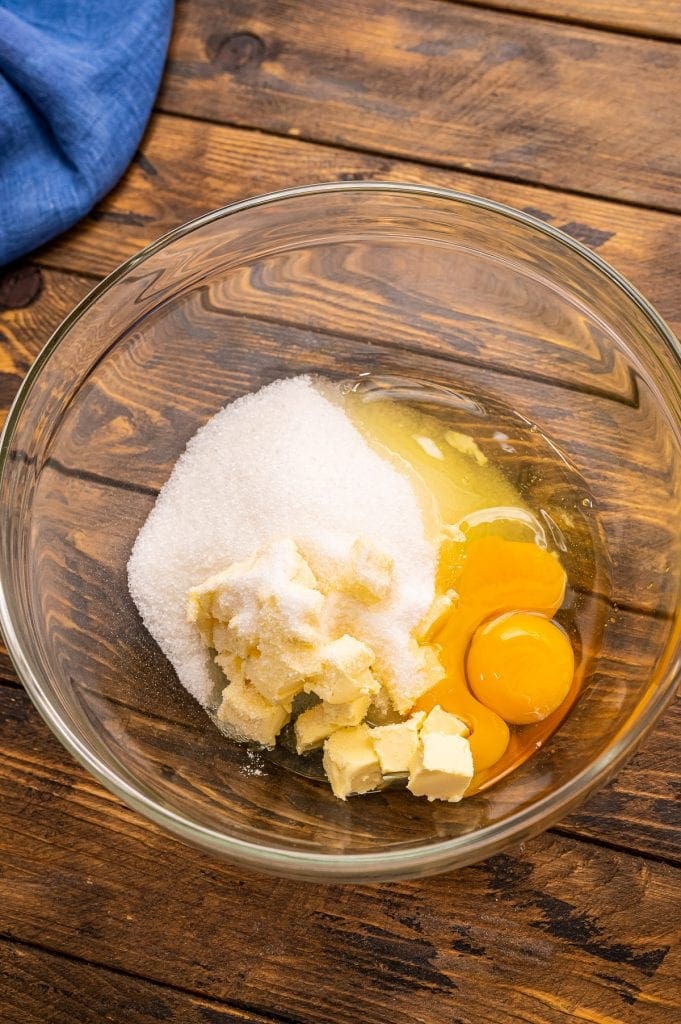 Glass bowl with butter, egg, oil, sugar before mixing.
