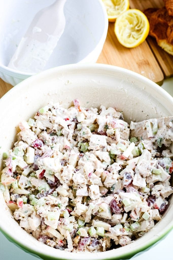 White bowl with filling for chicken salad sandwiches mixed together