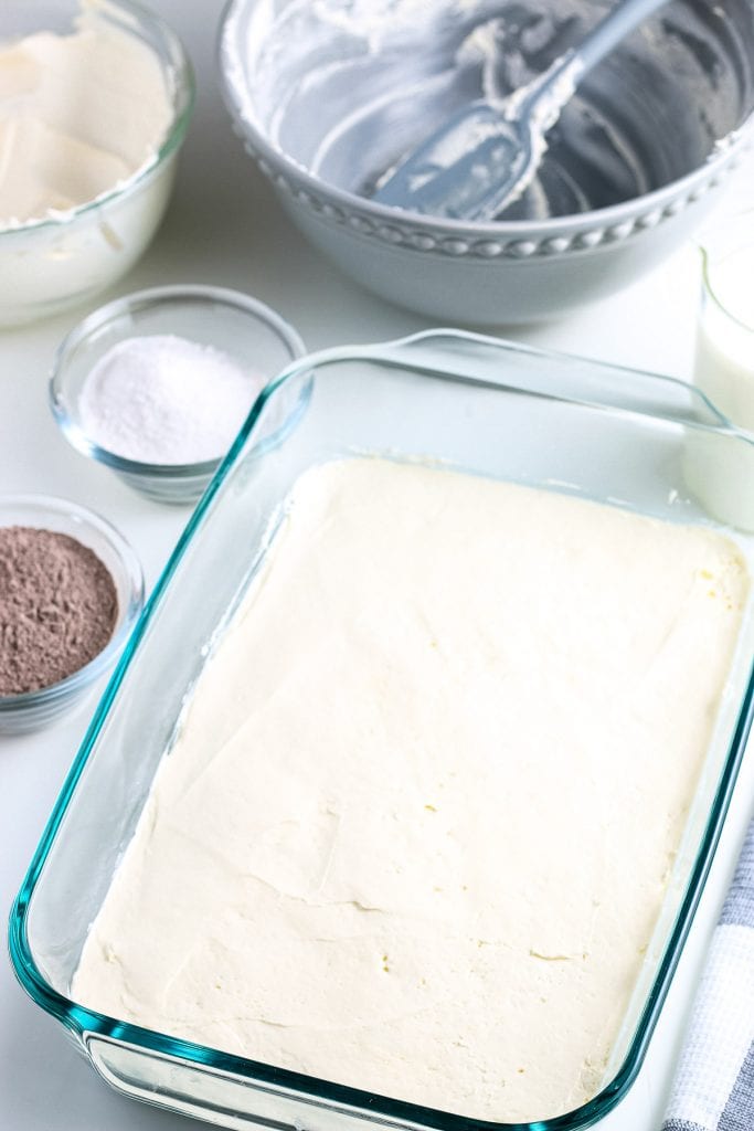 Glass baking dish with cream cheese layer.