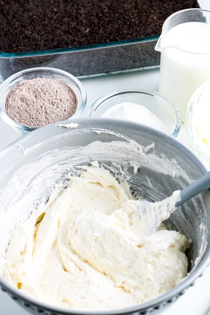 Gray bowl with cream cheese layer ingredients mixed.