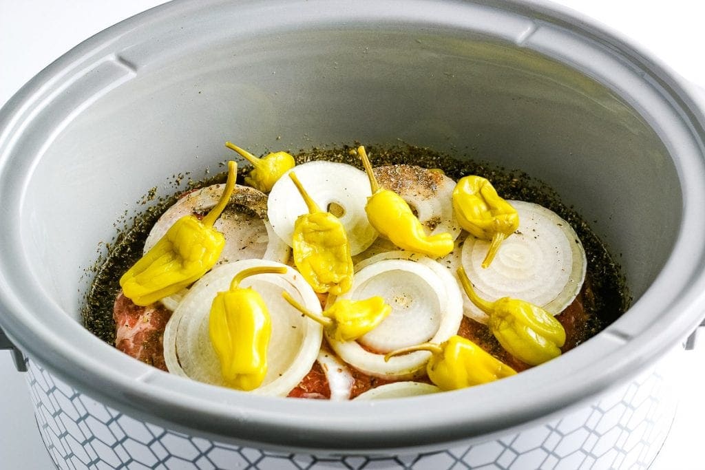 Crockpot liner with roast, onions and pepperoncinis peppers