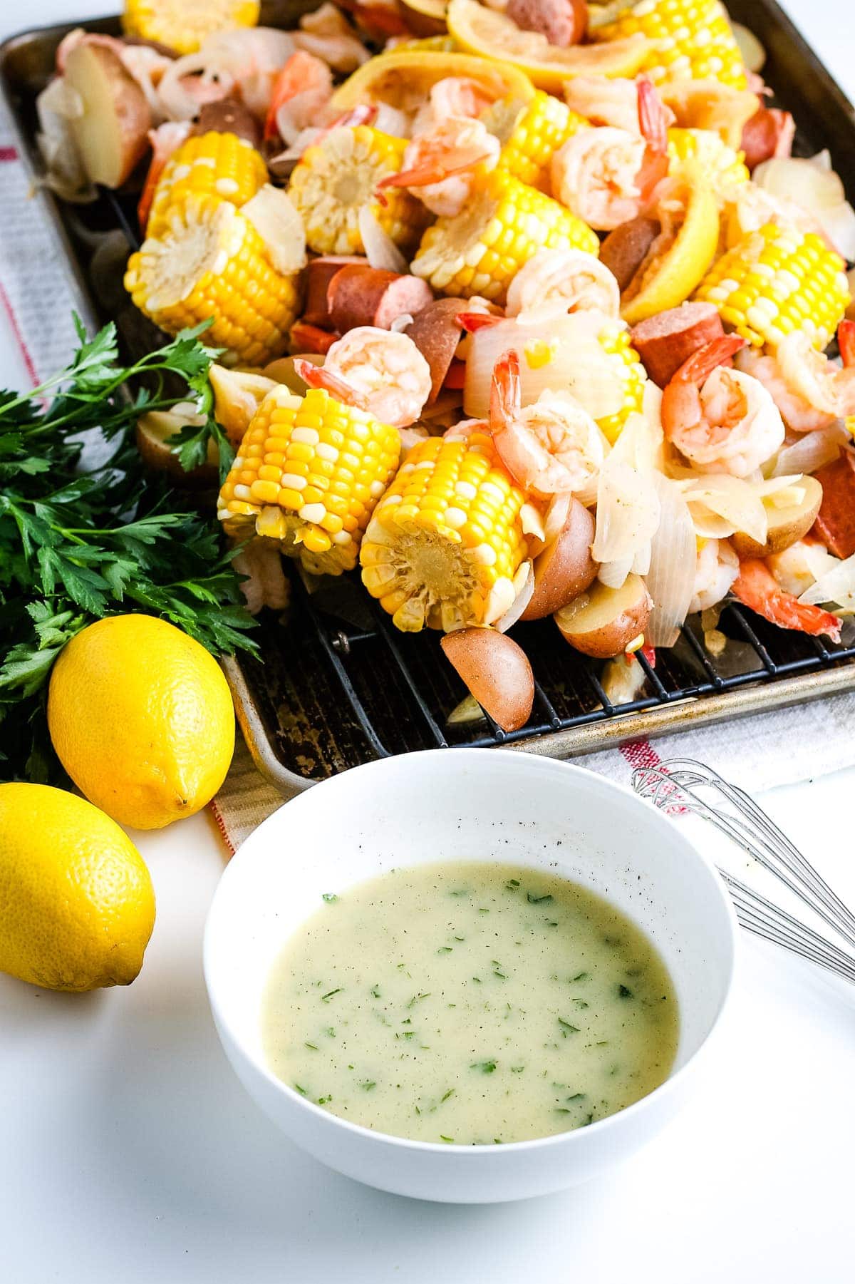 White bowl with seasoned butter in it before pouring on shrimp boil.