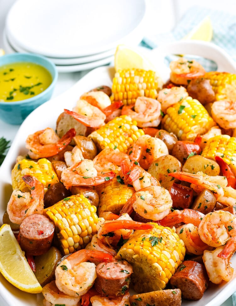 Shrimp Boil on what platter with white plates and napkin in background