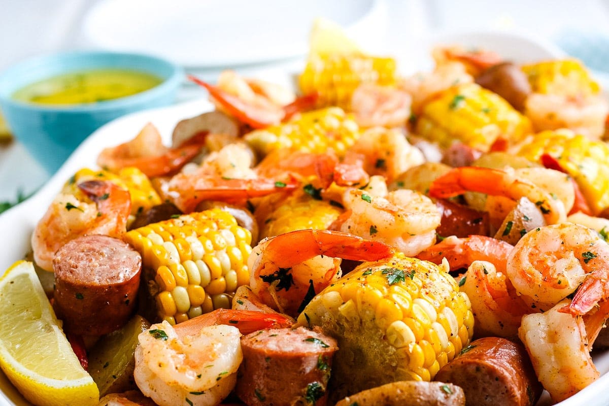 Close up image of finished shrimp boil on white platter