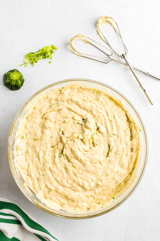 Glass bowl full of zucchini cake batter.