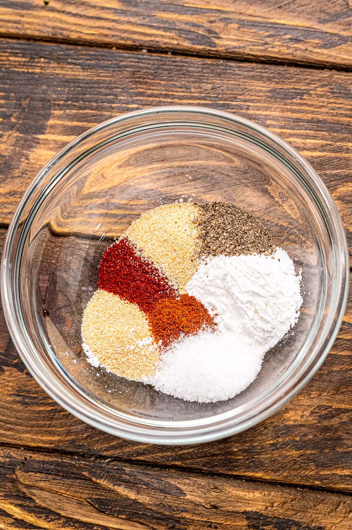 Glass bowl with spices before mixing together.