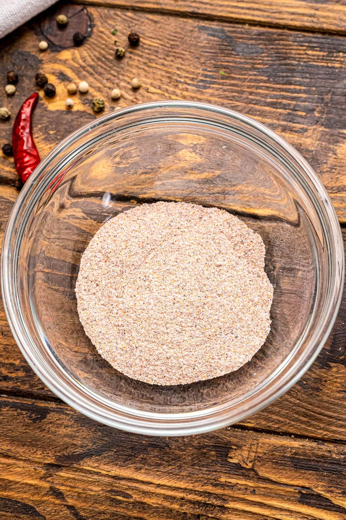 Glass bowl with rub ingredients mixed together.