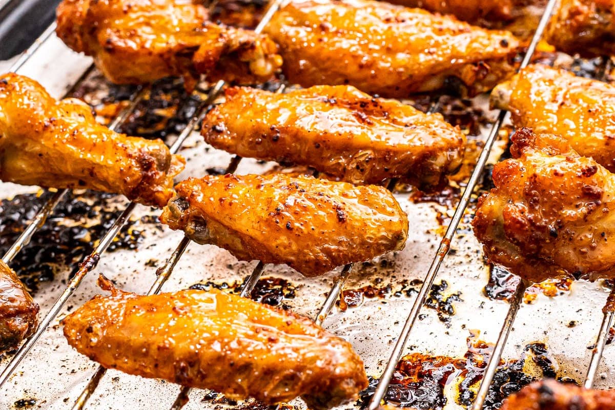 Chicken Wings on a oven rack over aluminum foil lined pan.