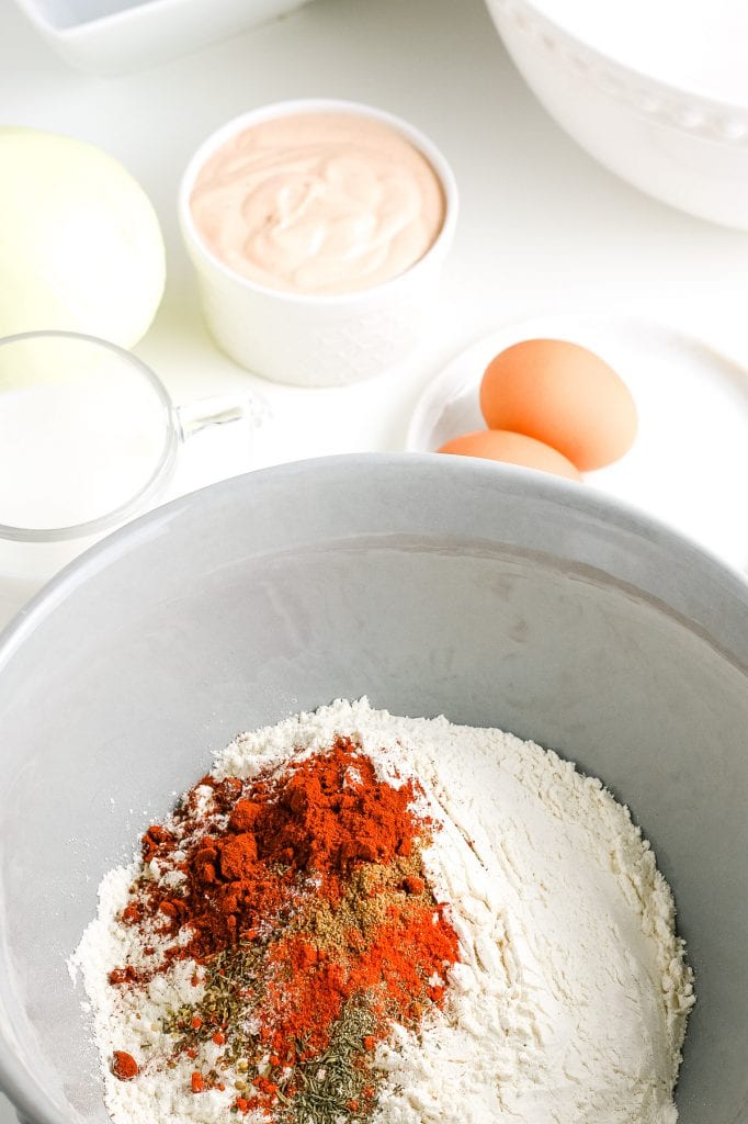 Gray bowl with flour and spices for batter before mixing.