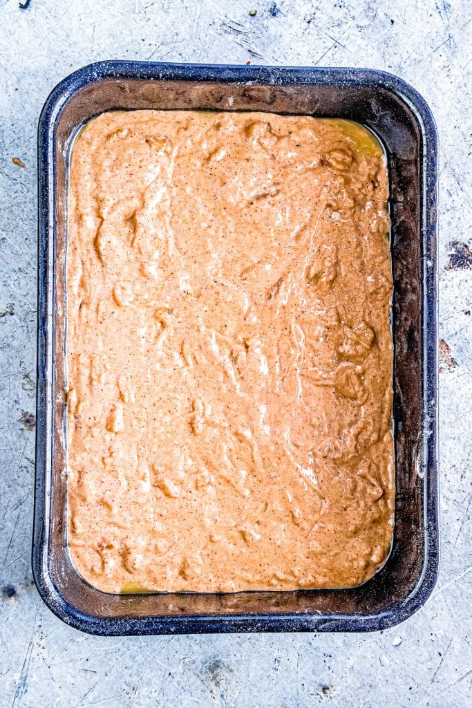 Dulce de Leche Apple Poke Cake batter in cake pan