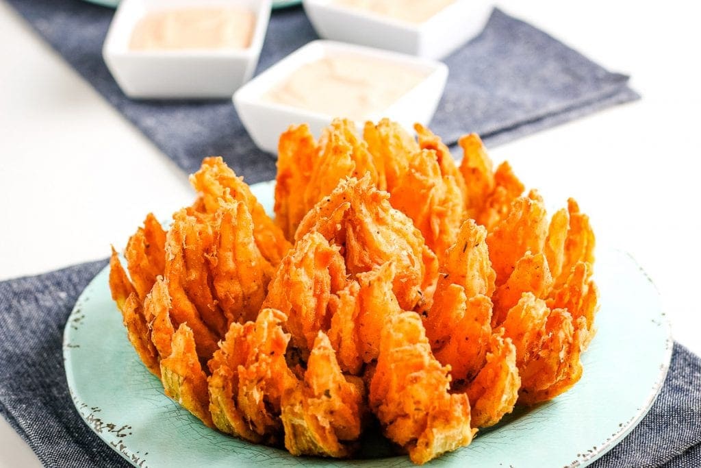 Light blue plate with a fried blooming on it.