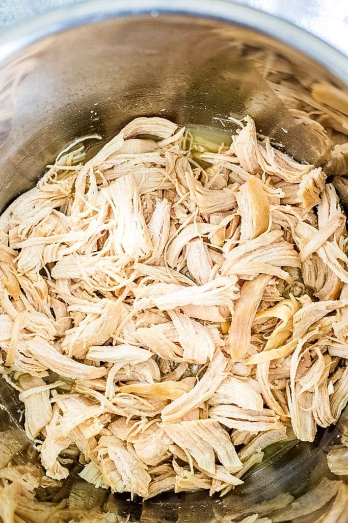 Instant Pot with shredded chicken breast in it.