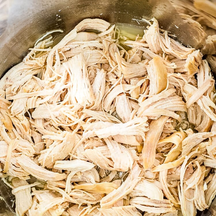 Instant Pot with shredded chicken breast in it.