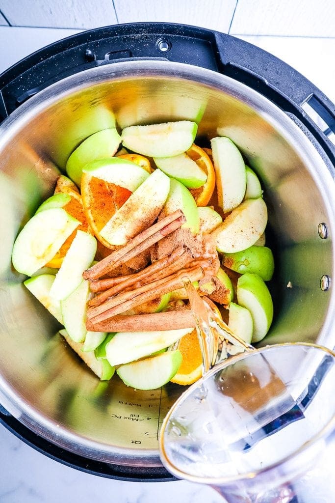 Instant Pot with ingredients to make Apple Cider.