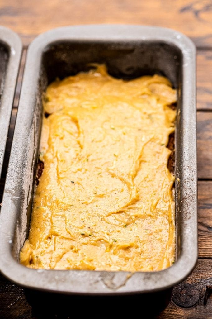 Metal loaf pan with pumpkin zucchini bread in it.