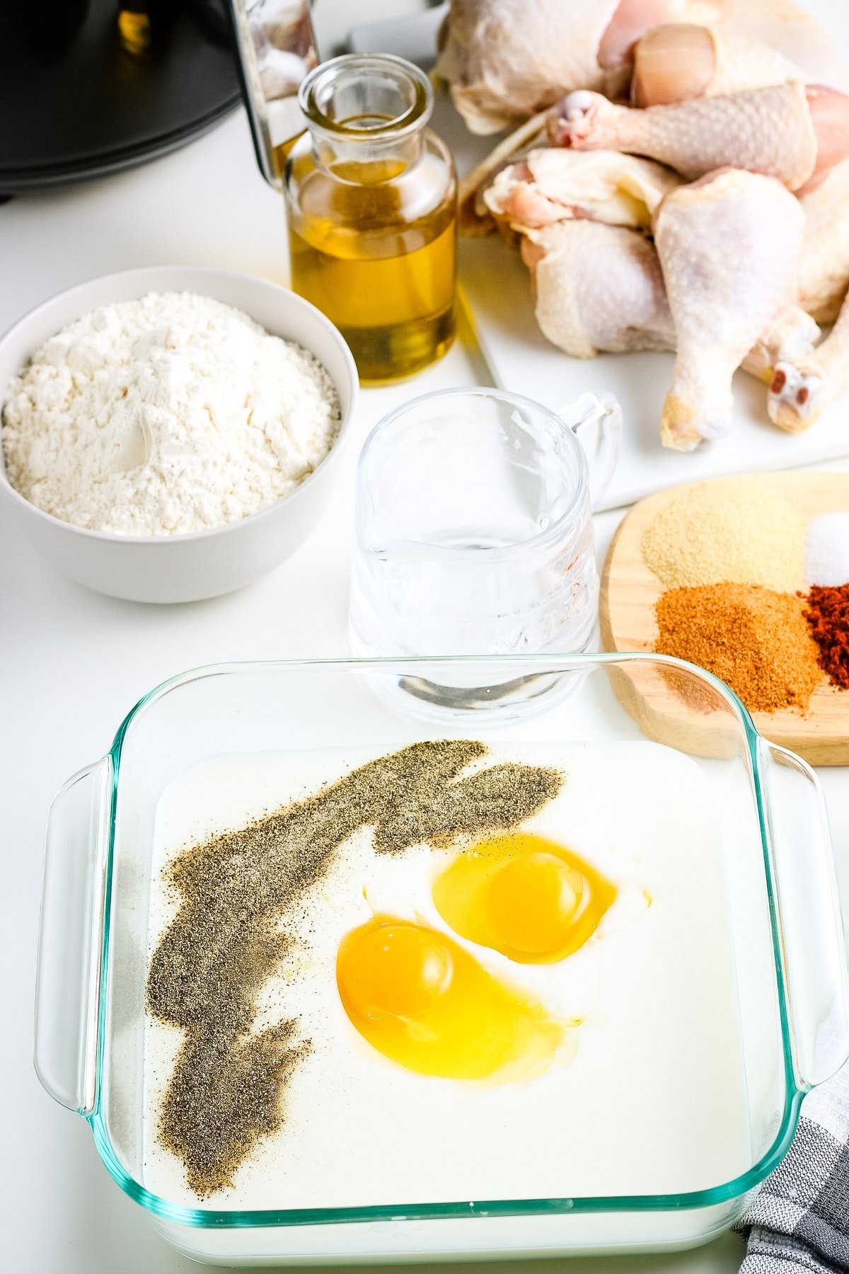 Buttermilk batter before whisking together in glass square dish.