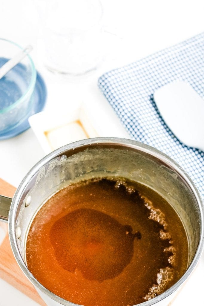 Saucepan with boiling caramel sauce.