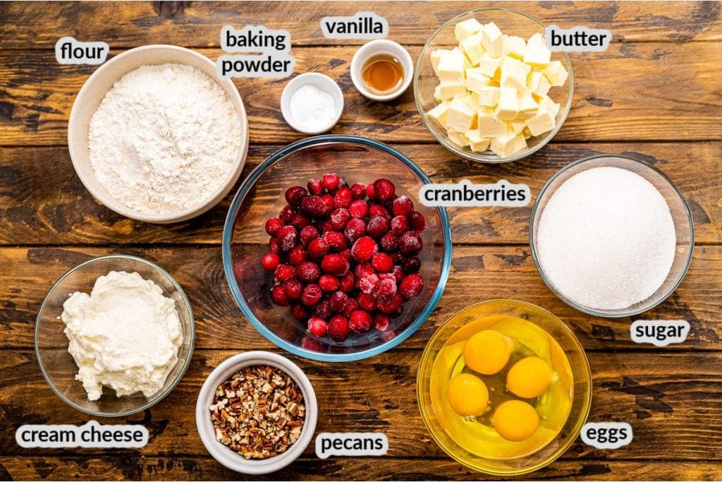 Cranberry Muffins Ingredients in bowls on wooden background