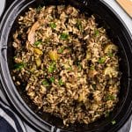 Black Crock Pot with Crock Pot Hamburger Wild Rice Casserole in it.