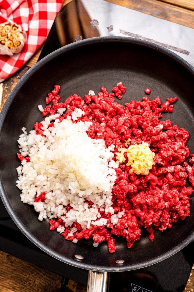 Black Skillet with onion, ground beef and garlic