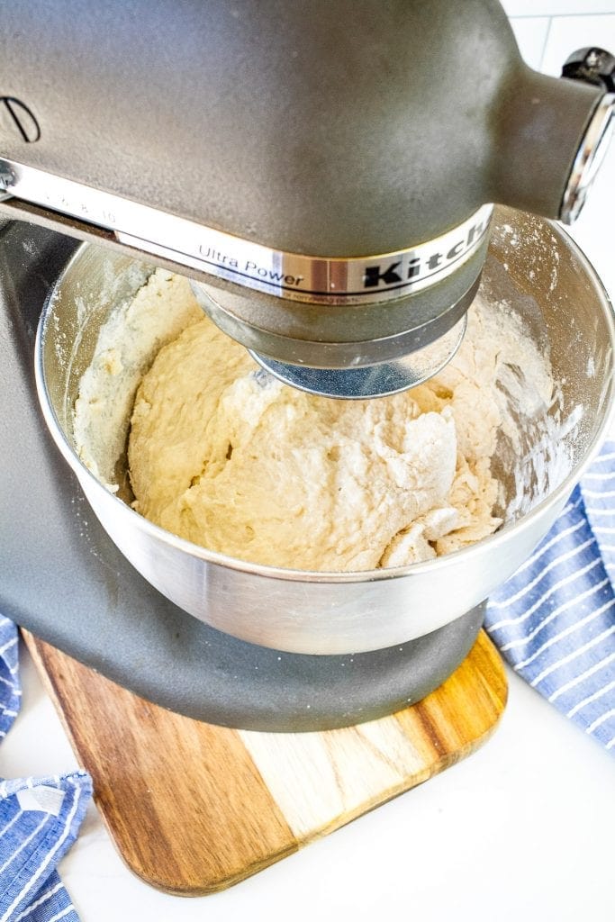 Whisk of stand mixer mixing dough ingredients together