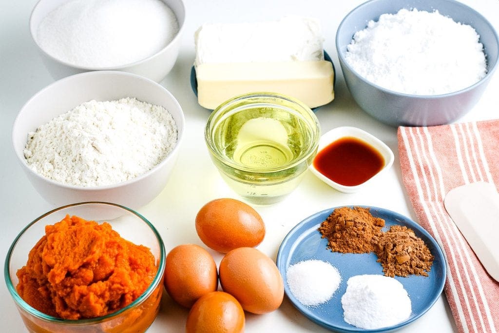 Ingredients for Pumpkin Cake in bowls or plates