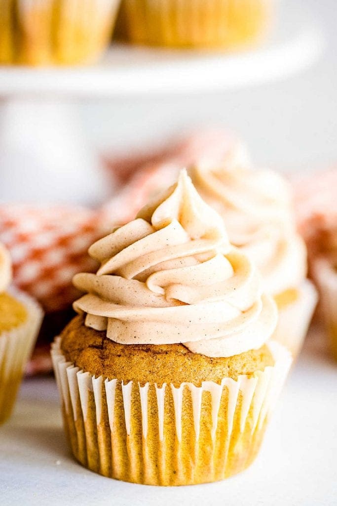 Close up image of a frosted pumpkin cupcake