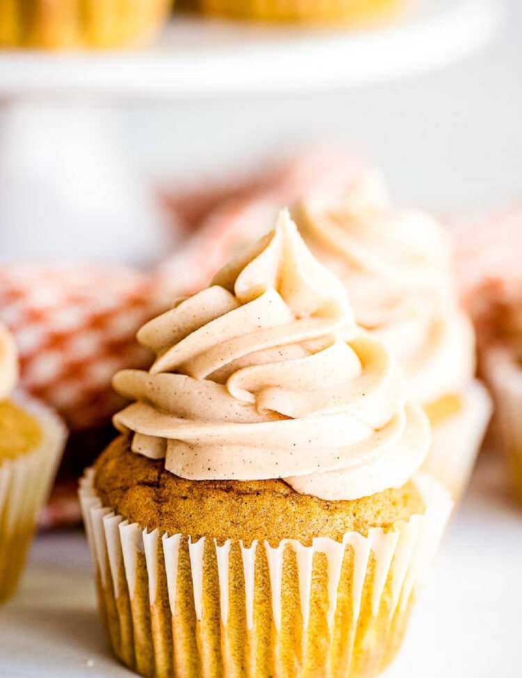 Close up image of a frosted pumpkin cupcake
