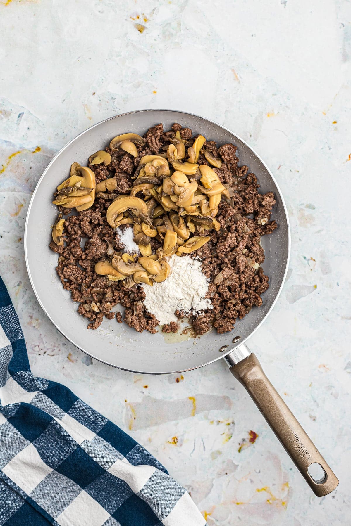 Browned ground beef mushrooms and flour in skillet