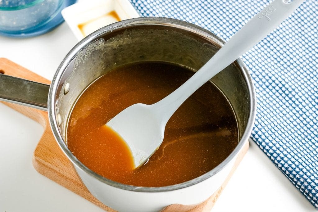 Homemade Caramel Sauce in saucepan with spoon