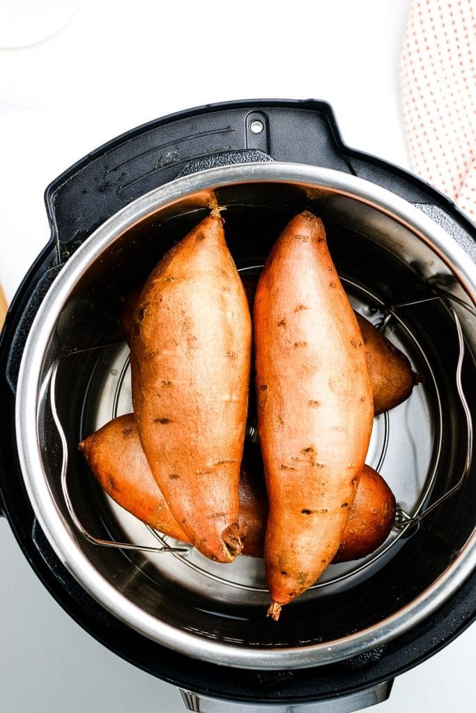 Four sweet potatoes in Instant Pot before cooking