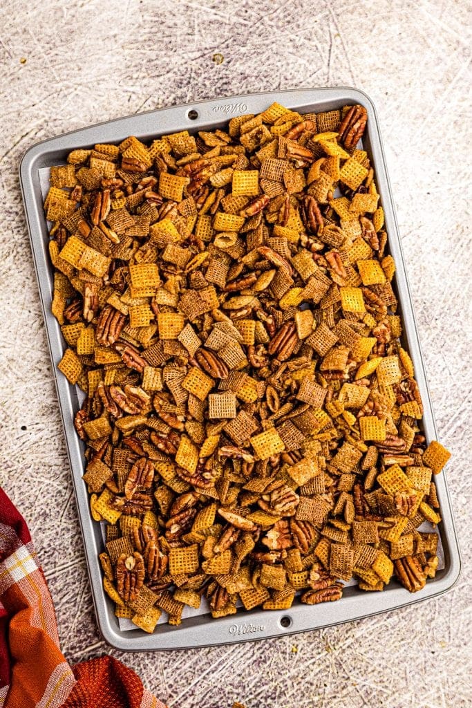 Sheet pan with pumpkin chex mix on it.