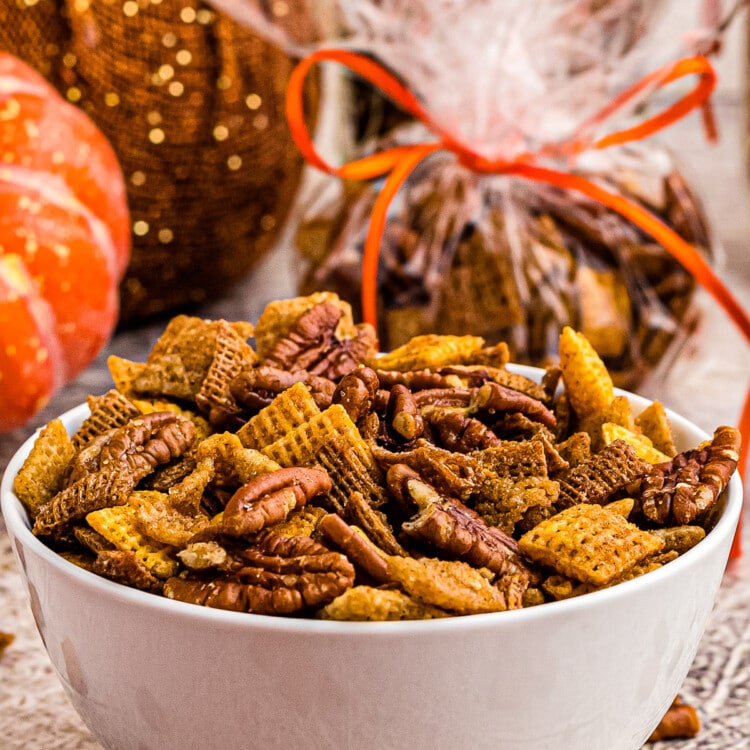 White bowl with pumpkin chex mix in it