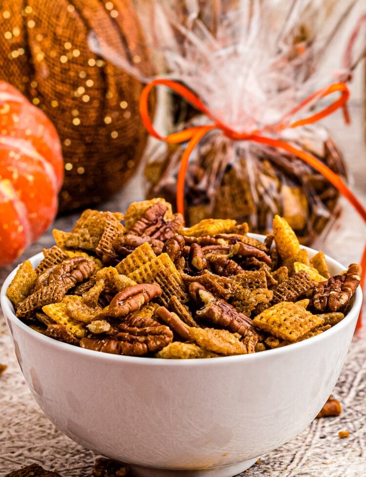 White bowl with pumpkin chex mix in it