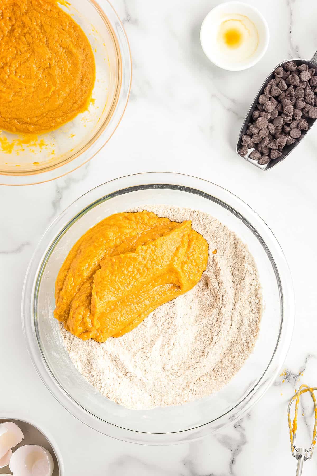 Bowl with wet and dry ingredients for chocolate chip pumpkin muffins