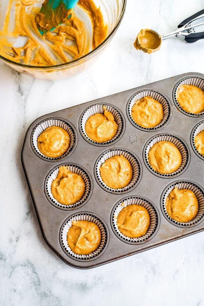 Pumpkin Cupcakes Batter in Muffin Tin on marble background