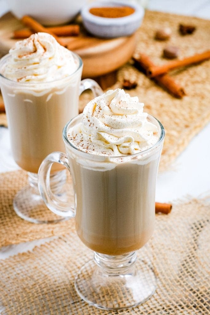 Pumpkin Spice Latte in mugs with whipped cream on top.