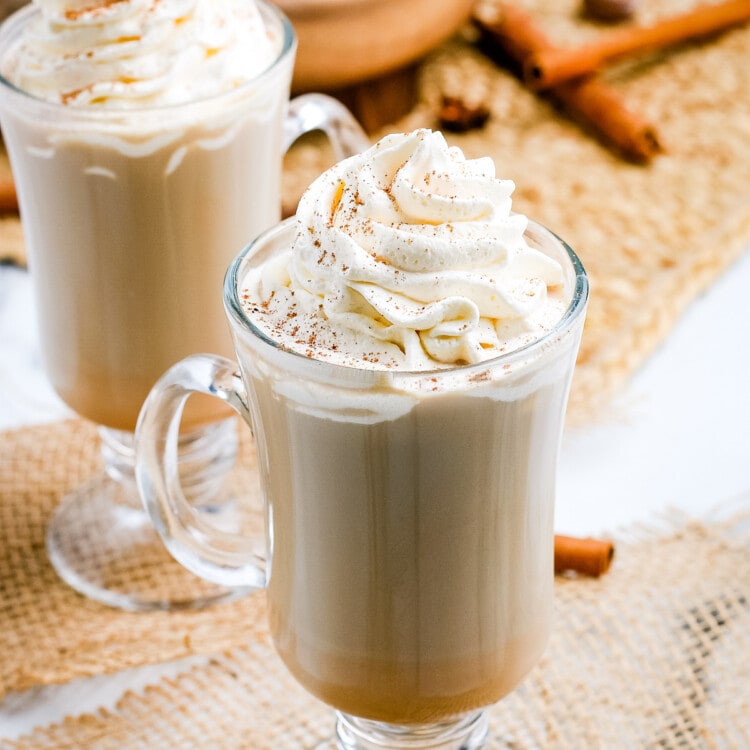 Pumpkin Spice Latte in mugs with whipped cream on top.