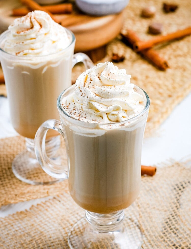 Pumpkin Spice Latte in mugs with whipped cream on top.