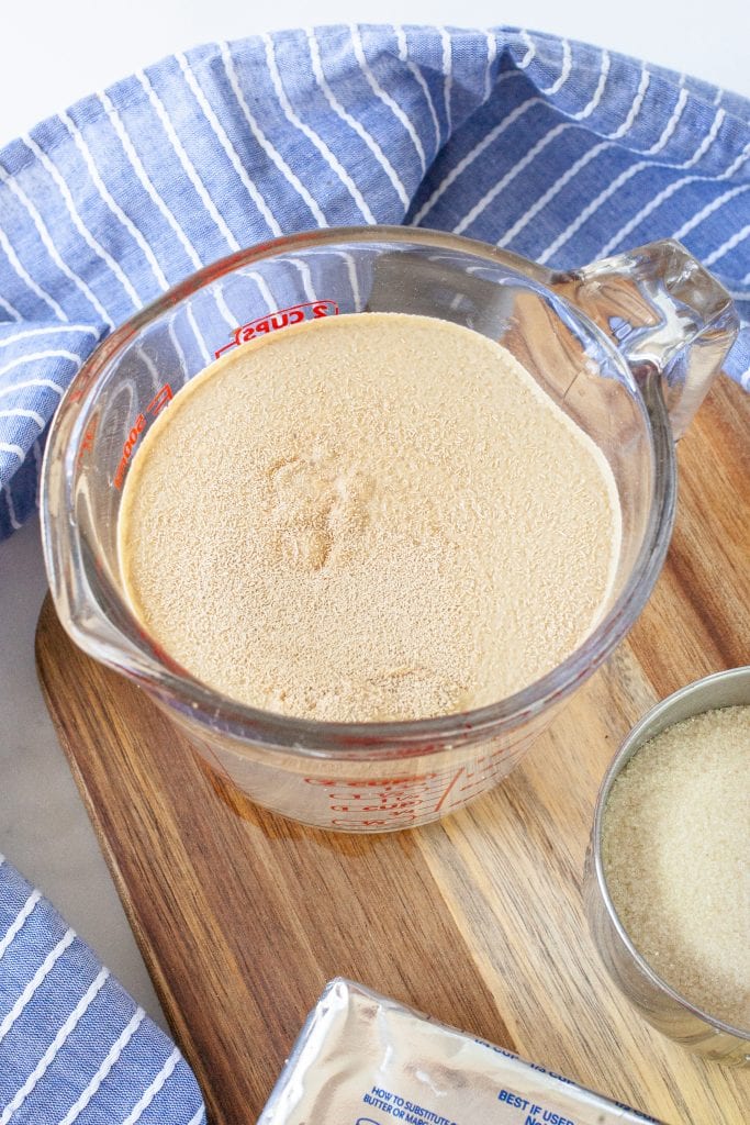 Glass measuring cup with yeast, water, sugar mixed together