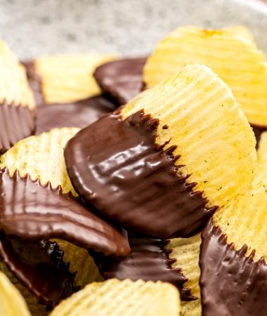 A stack of chocolate covered potato chips on plate