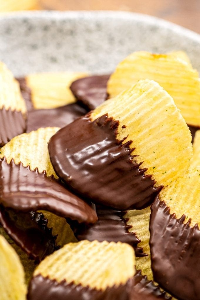 A stack of chocolate covered potato chips on plate