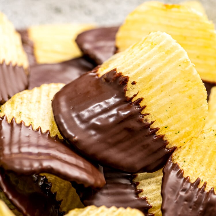 A stack of chocolate covered potato chips on plate