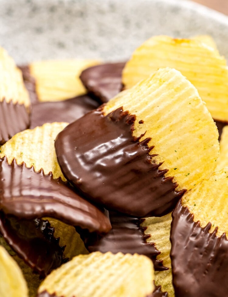 A stack of chocolate covered potato chips on plate