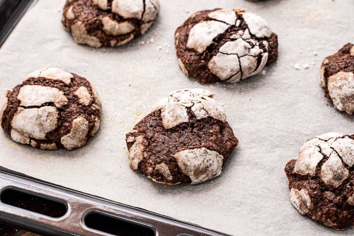 Baking sheet with Chocolate Crinkle Cookies on it