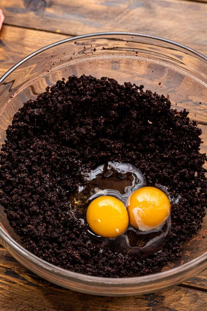 Eggs in chocolate cookie dough before mixing.